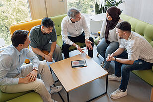 Ein Professor spricht mit einer kleinen Gruppe von Studierenden
